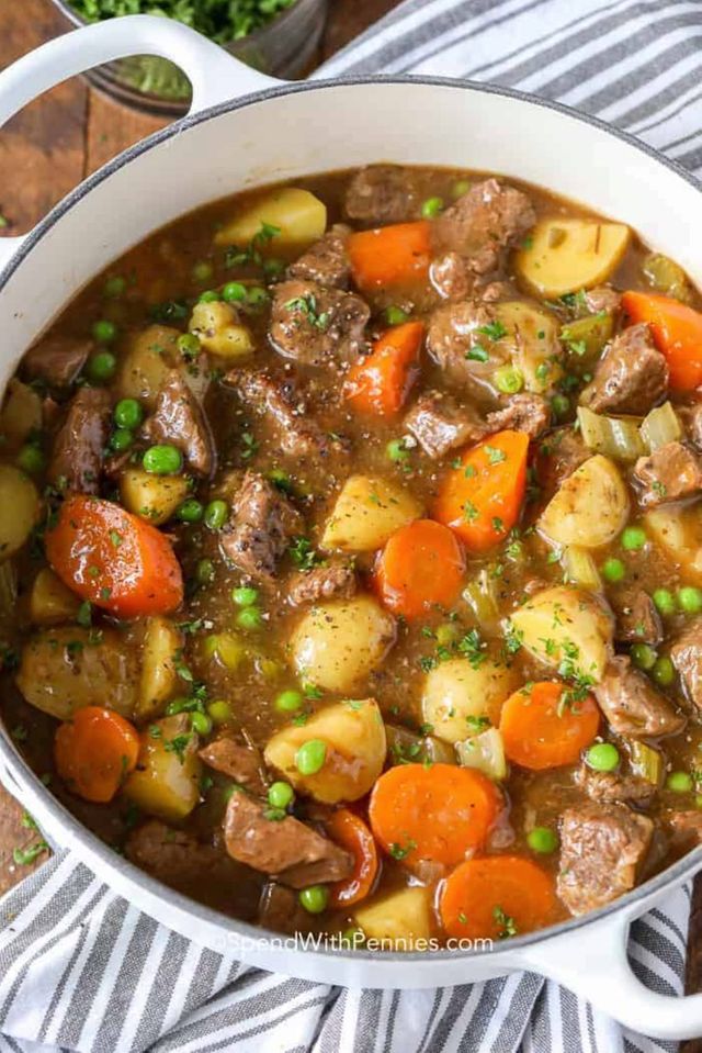 A pot of beef stew with carrots and celery